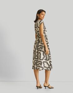 Experience elegance and versatility with our 'Deep V-neck Gathered Dress in Black Swirls.' Crafted from 100% Bemberg™ Crepe, this dress seamlessly transitions from the office to dinner with friends. The neutral black swirl design exudes sophistication while allowing easy accessory pairing. Its regular fit, coupled with cap sleeves and side slits, ensures comfort and style. The deep V-neck, adorned with a charming tie-up, adds a touch of allure to this chic outfit. Embrace the essence of summer dresses that combine style and practicality for various occasions. Wash in cold water or dry clean only Do not soak bleach or wring Line dry in shade Iron inside out on low heat Graceful Style, Gathered Dress, Neutral Prints, Dinner With Friends, Chic Outfit, Swirl Design, Draped Fabric, Dress 100, The Deep