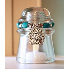 a glass jar with some beads on it