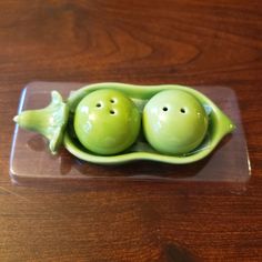 two peas are sitting in a green pea pod