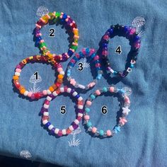 several bracelets with numbers on them sitting on a blue cloth