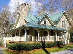 a white house with a blue roof surrounded by trees