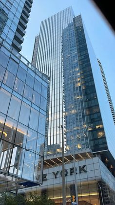 the sky is reflected in the glass windows of skyscrapers