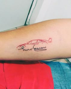 a person with a tattoo on their arm that has two cars in the same line