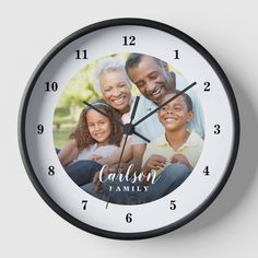 a black and white clock with a family photo on it