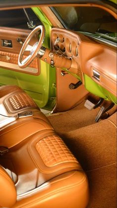 the interior of an old car with brown leather seats and green dash board trims