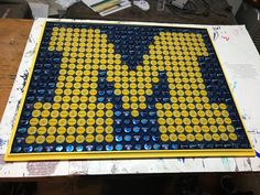 a yellow and blue mosaic with the word mickey on it