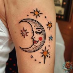 a woman's arm with a crescent and stars on it