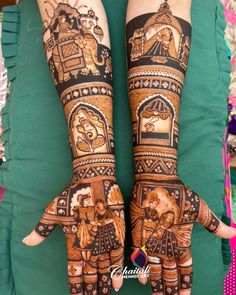 two hands with henna designs on them