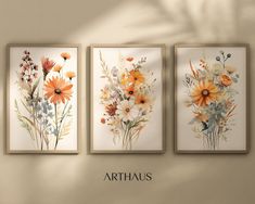 three floral paintings hanging on the wall