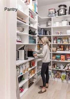 a woman is looking for food in the pantry