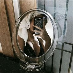 a woman taking a selfie in a mirror with her cell phone up to her face