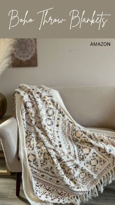 a white blanket sitting on top of a couch