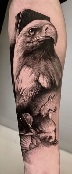 an eagle with a hat on it's head is shown in this black and white tattoo