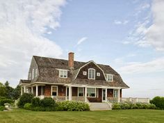 a large house sitting on top of a lush green field