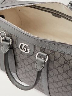 Gucci's versatile 'Ophidia' duffle bag works well for a weekend getaway or as an airplane carry-on. Made in Italy from the label's 'GG Supreme' coated-canvas, it's trimmed with leather and has sleek silver-tone hardware. The adjustable shoulder strap can be detached if you prefer to use the two top handles. Designer Double Handle Duffle Bag, Designer Coated Canvas Travel Bag With Handles, Designer Top Handle Duffle Bag With Dust Bag, Designer Travel Bag With Top Carry Handle, Designer Rectangular Travel Bag, Gucci Travel Satchel Bag, Designer Travel Satchel With Handles, Designer Satchel With Handles For Travel, Designer Tote Duffle Bag For On-the-go