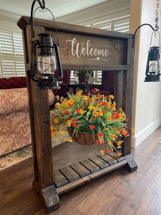 a potted plant sitting on top of a wooden shelf next to a welcome sign