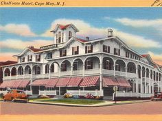 an old postcard shows the front and side of a large white building with red awnings