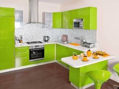 a kitchen with green cabinets and white counter tops