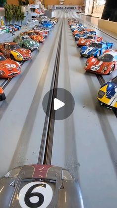 a group of toy cars sitting on top of a race track