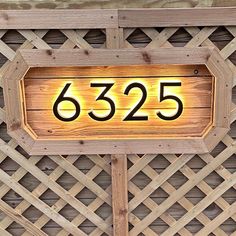 a wooden sign with the number 535 on it's side is lit up