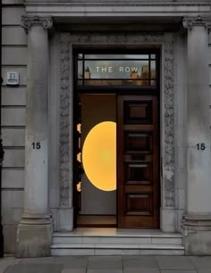 an entrance to a building with the words the row lit up on it's front door