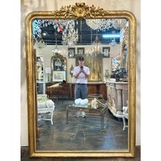 a man standing in front of a large mirror