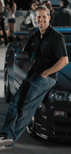 a man sitting on the hood of a car