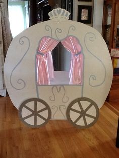 an inflatable horse drawn carriage with pink curtains