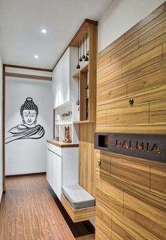 a kitchen with wood floors and white walls has a drawing on the wall behind it