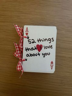 a card that says, 65 things that love about you is tied with a red checkered ribbon