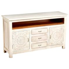 a white wooden entertainment center with drawers and carvings on the front, sitting against a white background