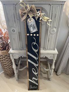 a wooden sign that says love and there is a vase with flowers on it