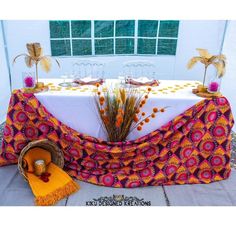 the table is decorated with orange and pink decorations