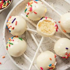 white cake pops with sprinkles on a plate