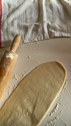 an uncooked loaf of bread next to a rolling pin