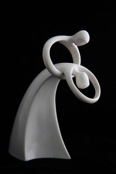 a white sculpture is shown against a black background