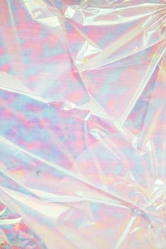 an abstract image of plastic wrap on the ground with pink and blue hues in it