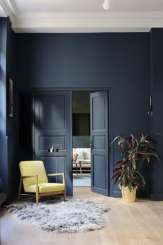 a living room with blue walls and wooden floors