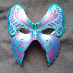 Butterfly mask - Hand-painted  Butterfly Mask. Full face party mask. The masquerade mask is Hand-painted with metallic gel pens and adorned with sparkling jewels. The mask is lined and attaches with an elastic strap. Great for Masquerade and Mardi Gras. Fits most. designAnn Original Mask See more at http://www.designAnn.etsy.com Butterfly Mask Design, Face Mask Design Art, Painted Masks, Mask Butterfly, Aesthetic Mask, Mask Full Face, Lace Parasol, Butterfly Mask, Painted Butterfly