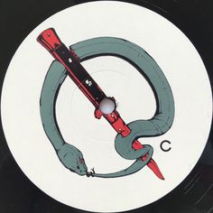 a white disc with an image of a snake holding a knife in it's mouth