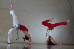 three people in red and white outfits doing yoga poses with their hands on the floor