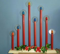 a bunch of red candles sitting on top of a table