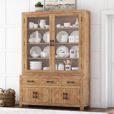 a wooden china cabinet with glass doors and dishes on it's shelves in a living room