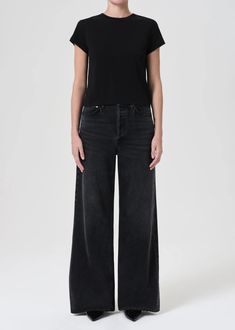 Our Dame Jean, featuring a waist accentuating high-rise, a relaxed cut through the hips and a wide leg. Create an ultra-flattering silhouette by styling it with a sleek tee. Hitch Intended to have a relaxed fit. For a higher, closer fit, we recommend sizing down. Looks Like: Lived-in washed black with subtle whiskering and fading and a finished hemFeels Like: Non-stretch Regenerative cotton that offers a luxurious drape for all-day movement Closure: Button Fly Rise: 12 1/2" Inseam: 32 1/2" Leg O Luxury Wide-leg Relaxed Fit Jeans, Luxury High Rise Relaxed Fit Jeans, Luxury Washed Black Fitted Jeans, Luxury Stretch Black Jeans, Luxury Relaxed Fit Jeans, Luxury High Waist Black Jeans, Luxury High-rise Faded Jeans, Luxury Washed Black Jeans, Luxury High Rise Faded Jeans