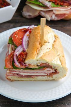 a cut in half sandwich sitting on top of a white plate