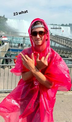 a man in a pink raincoat and sunglasses