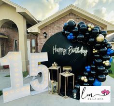 a birthday party with balloons and decorations in front of a house that says happy birthday