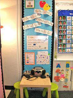 a table and chair in front of a bulletin board