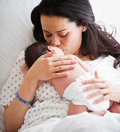 a woman holding a baby in her arms