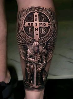 a man's leg with a cross and knight on it